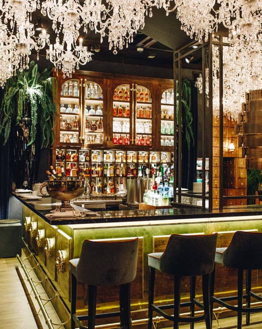 Bar with barstools and chandeliers at Feroz Barcelona