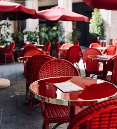 outdoor dining seating red woven chairs parasols