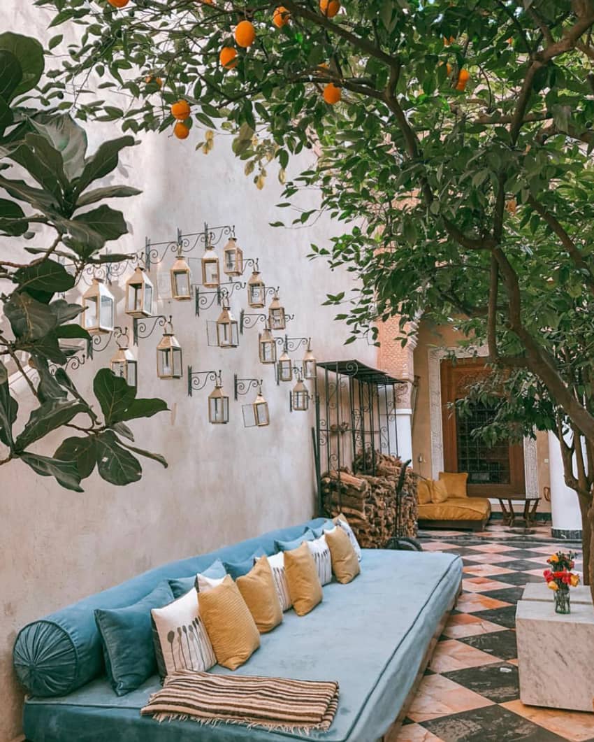 El Fenn Marrakech courtyard blue long couch firewood