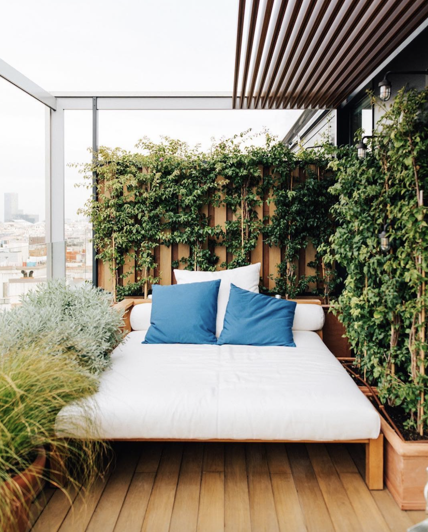 The Edition Barcelona rooftop bed with blue cushions