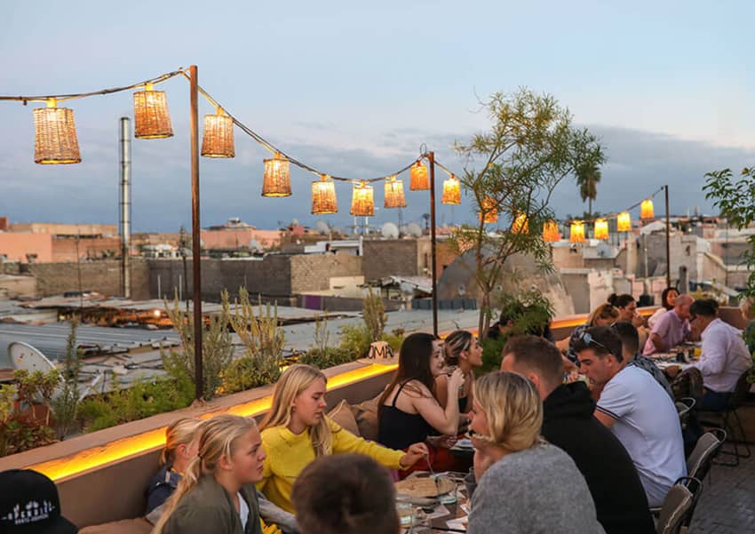 international dining clients hanging lights rooftop