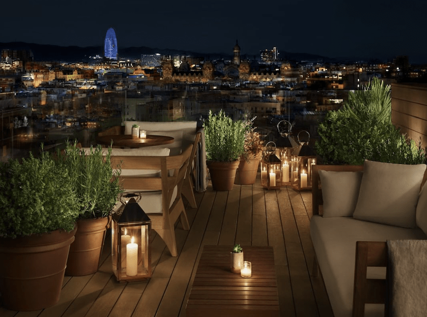 rooftop terrace with sofas lights en city view