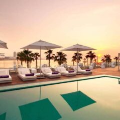 sunset pool deck white parasols loungers