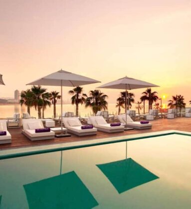sunset pool deck white parasols loungers