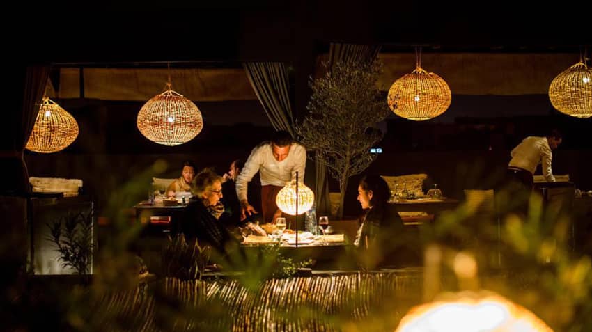 Terrasse Des Epices dining clients server lit lamps