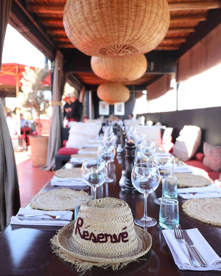 Terrasse Des Epices long table reserved straw hat