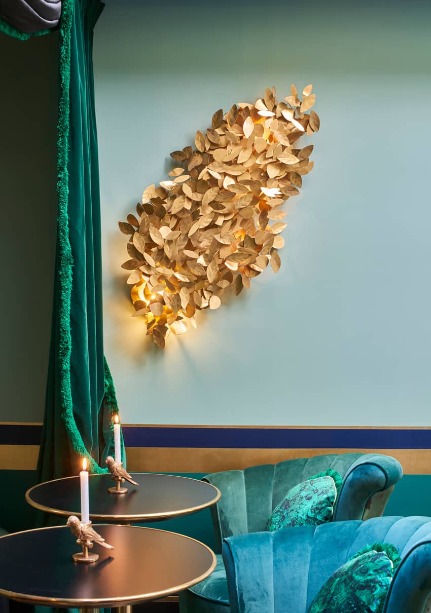 gold leaves lighted wall decor emerald curtain couches