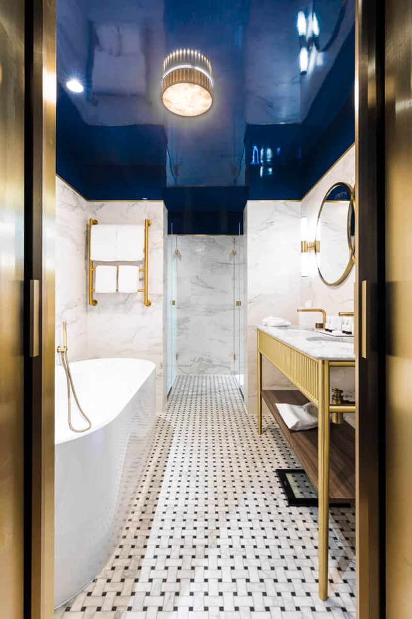 large bathtub double wash basin reflective blue ceiling