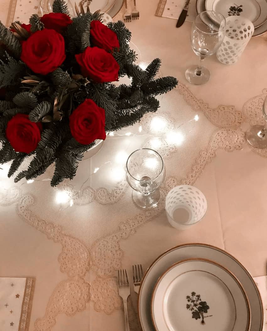 red roses bouquet lace tablecloth white string lights