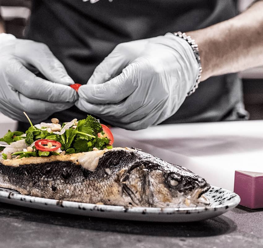 chef preparing whole grilled fish