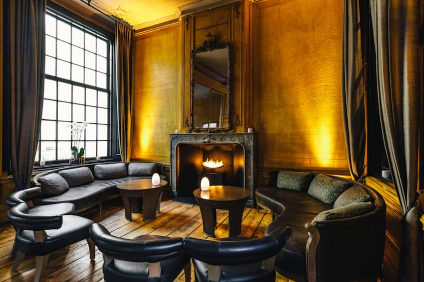leather chairs around the fireplace by window