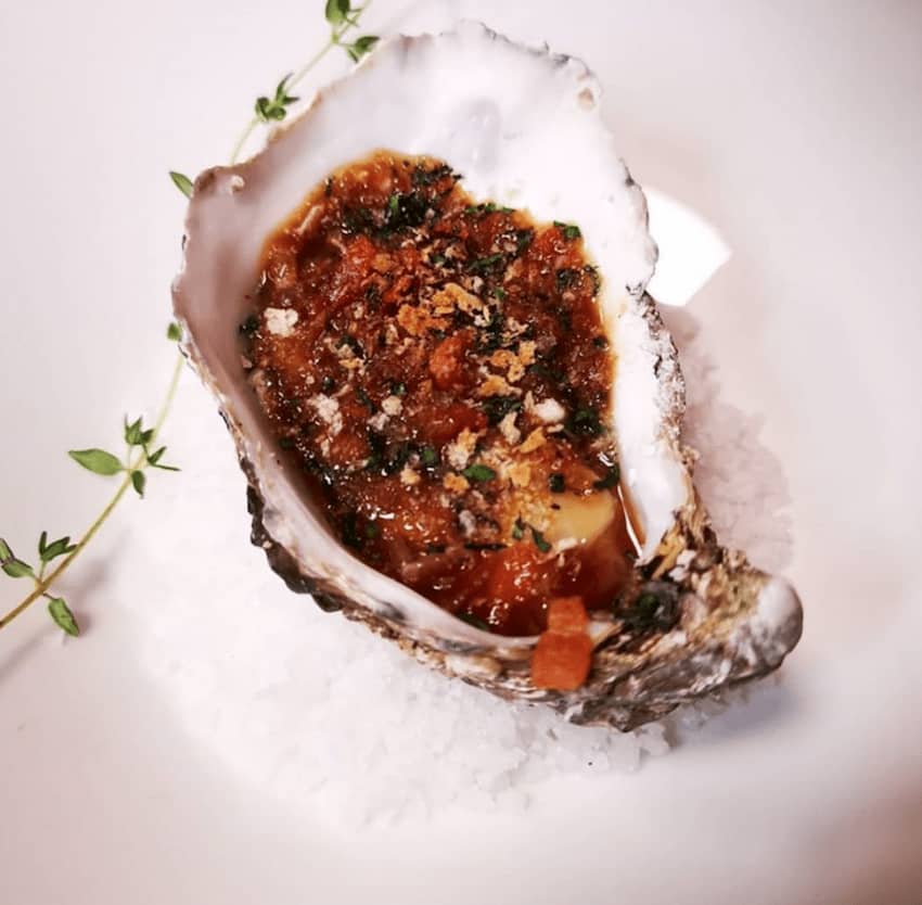 oysters kilpatrick on a bed of salt