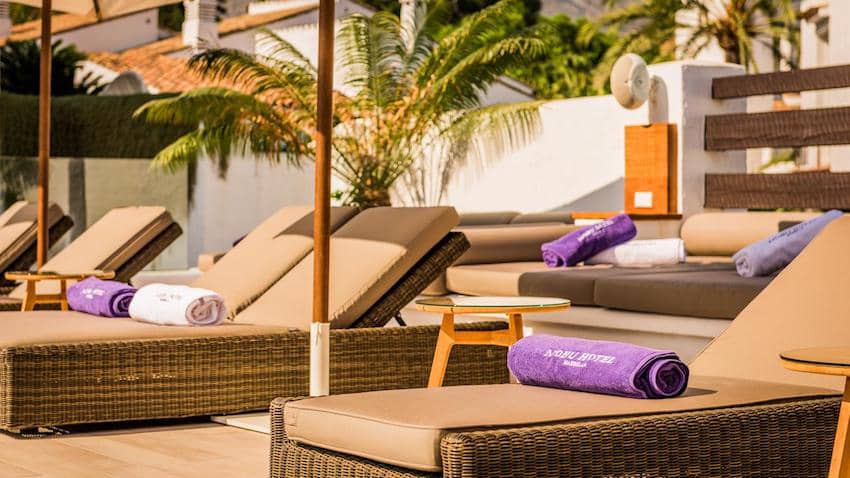 rattan brown loungers by the pool