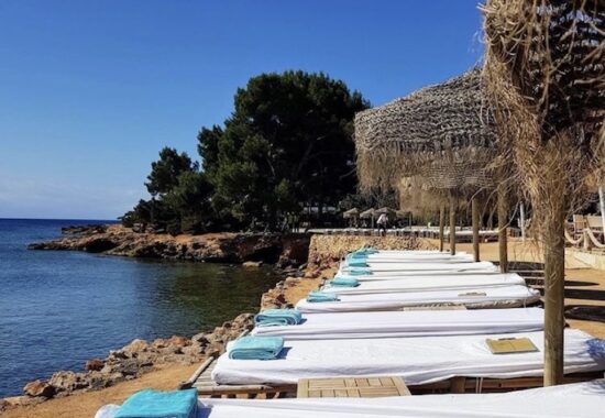 sunbeds blue towel wooden umbrellas