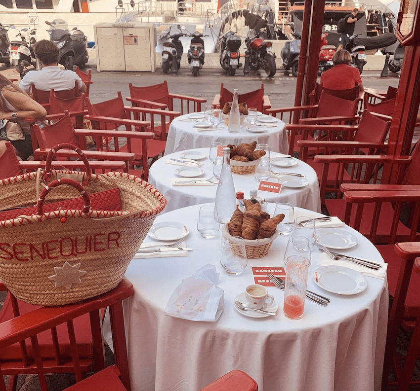 Senequier red chairs table croissant bag