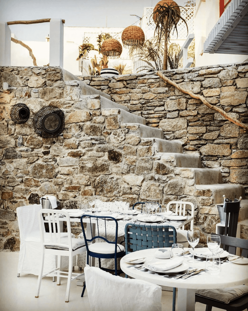 stone wall table chairs outside