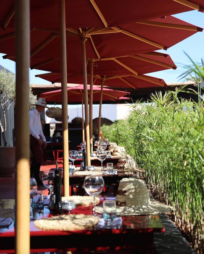 bamboo lined outdoor dining area maroon parasols